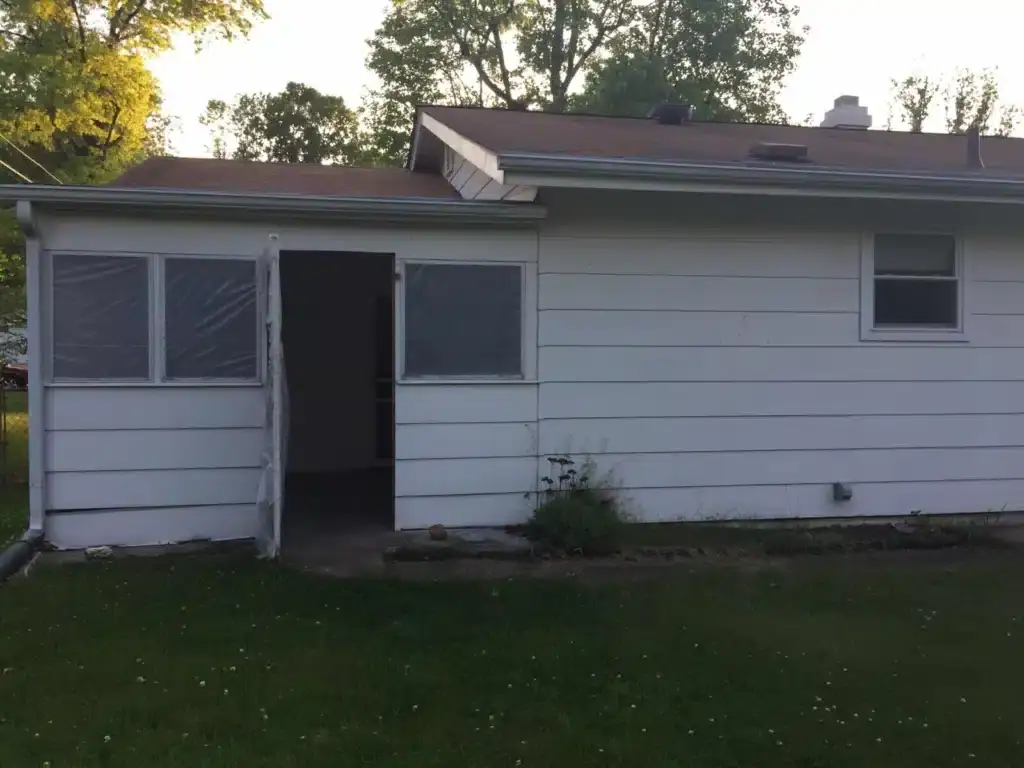 The front of a house with white siding in St. Louis