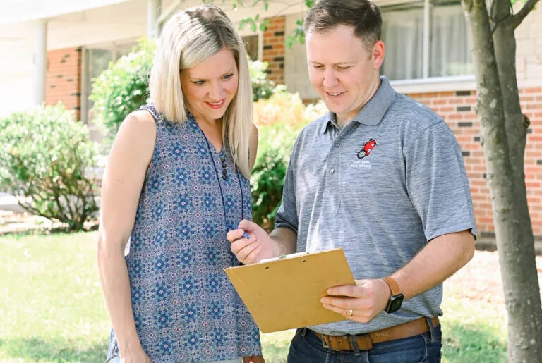 Creve Coeur 10 Lane and a client looking at a clipboard